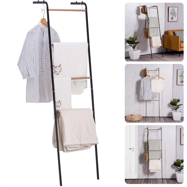 Freestanding black metal and wood towel rack with clothes and towels displayed in a modern bathroom setting.