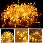 Warm white LED Christmas lights on transparent wire for indoor and outdoor decoration, creating a magical atmosphere.