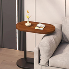 Stylish Cheqo® bijzettafel in metal and wood next to a sofa, featuring a minimalist design with a vase and book on top.