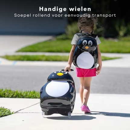 Child with Cheqo® penguin trolley and backpack set on sidewalk